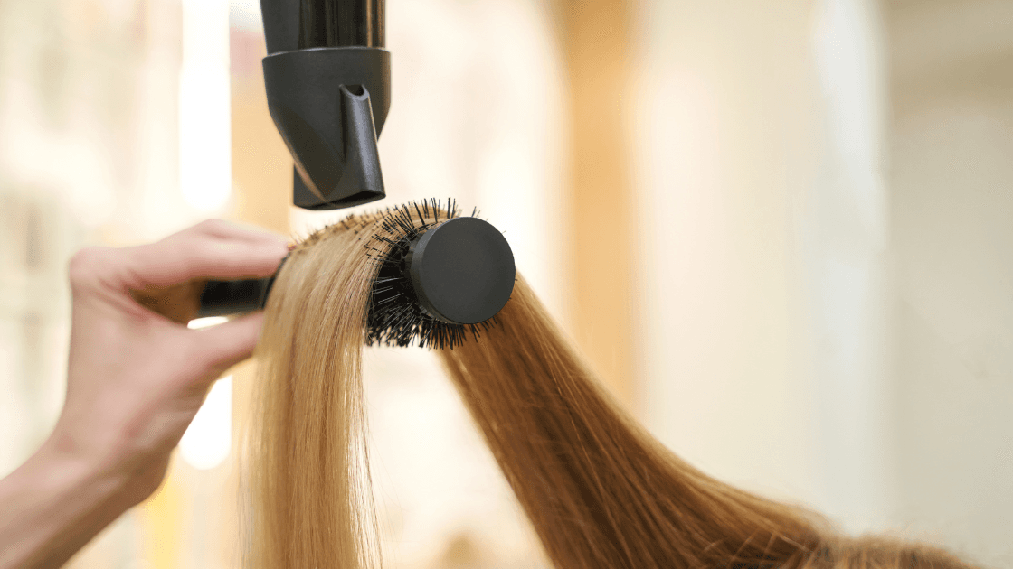 Stylist blow-drying a client’s hair at Simon Warwick Salons, Maida Vale – part of the complimentary follow-up blowdry for new haircut clients.